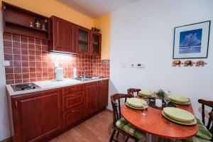 a kitchen with a table with chairs and a sink at Little Mountain Apartment in Ostružná +9 photos