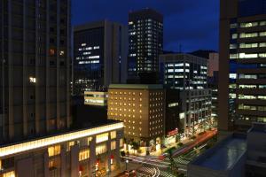 a view of a city at night with buildings at Hotel Viamare Kobe in Kobe