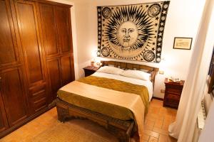 a bedroom with a bed with a picture on the wall at Parco delle Nazioni - Relax Grand Resort in Castel di Decima