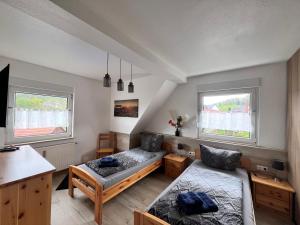 a room with a bed and a couch and two windows at Ferien- und Monteurwohnungen Andrej in Eisenach