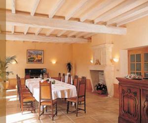 a dining room with a white table and chairs at Hôtel des Pyrénées in Saint-Jean-Pied-de-Port