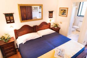 a bedroom with a large bed and a mirror at Parco delle Nazioni - Relax Grand Resort in Castel di Decima +104 photos