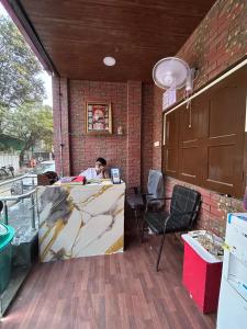 a man sitting at a counter in a restaurant at HOTEL Welcome in Jāmb