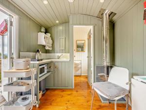 a kitchen with green walls and a table and a chair at 1 Bed in Paignton oc-93063 in Marldon +7 photos