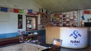 a restaurant with a counter and a bar in a room at Hotel mardi station and restaurent in Astam