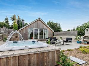 a hot tub in a backyard with a patio at 1 Bed in Paignton oc-93061 in Marldon