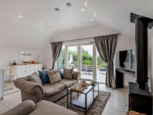 a living room with a couch and a table and a kitchen at 1 Bed in Paignton oc-93061 in Marldon