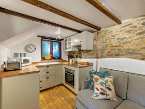 a living room with a couch and a kitchen at 1 Bed in Yelverton oc-93333 in Yelverton