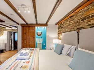 a bedroom with a bed and a brick wall at 1 Bed in Yelverton oc-93333 in Yelverton
