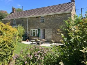 a brick house with a picnic table in the garden at 2 Bed in Bridport oc-58848 in Powerstock +22 photos
