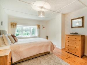 a bedroom with a bed and a window and a dresser at 2 Bed in Bridport oc-58848 in Powerstock