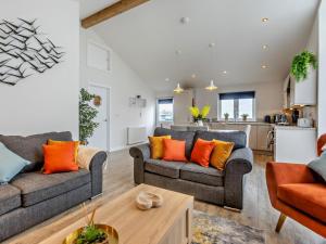 a living room with two couches and a kitchen at 3 Bed in Bideford oc-64410 in Northam