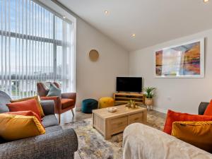 a living room with two couches and a tv at 3 Bed in Bideford oc-64410 in Northam