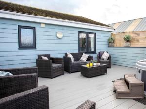 a patio with couches and chairs and a table at 3 Bed in Bideford oc-64410 in Northam