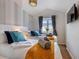 a bedroom with two beds and a window at 3 Bed in Bideford oc-64410 in Northam