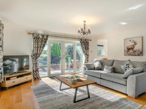 a living room with a couch and a tv at 4 Bed in Bideford oc-91814 in Northam