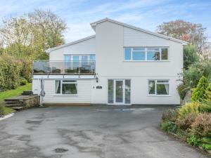 a white house with a parking lot at 4 Bed in Bideford oc-91814 in Northam