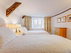 a bedroom with two beds and a window at 2 Bed in Exeter oc-90455 in Tedburn Saint Mary