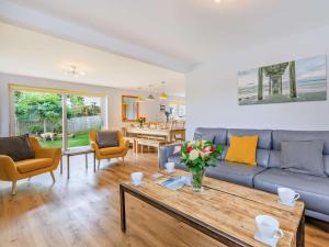 a living room with a couch and a table at 5 Bed in Bridport oc-83584 in Charmouth