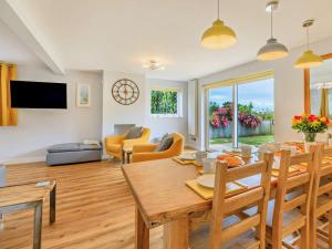 a dining room and living room with a table and chairs at 5 Bed in Bridport oc-83584 in Charmouth