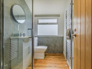 a bathroom with a toilet and a sink and a window at 5 Bed in Bridport oc-83584 in Charmouth +32 photos