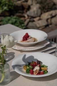 two plates of food sitting on a table at Garni-Hotel Der Forsterhof in Lagundo