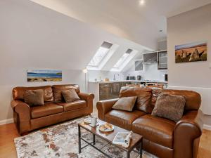 a living room with two leather couches and a table at 2 Bed in Beaworthy oc-87085 in Highampton