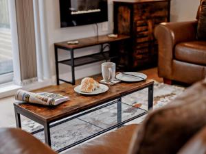 a living room with a table with a plate of food on it at 2 Bed in Beaworthy oc-87085 in Highampton