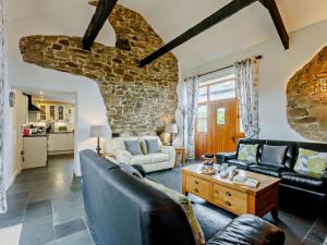 a living room with a couch and a table at 4 Bed in Bideford oc-owlbr in Clovelly