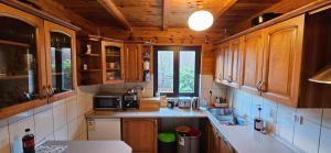 a kitchen with wooden cabinets and a counter top at Chata Górska Sowa, Cały Dom tylko dla Was in Podgórzyn