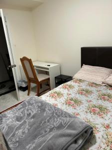 a bedroom with a bed and a desk and a chair at V-Swim Suite-1 in Toronto