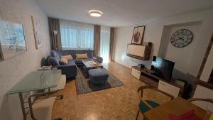 a living room with a couch and a tv at Ferienwohnung Hinterberg in Fürstenstein