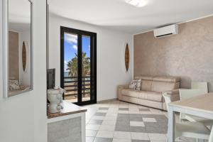 a living room with a couch and a table at Case Vacanze Celeste in Marzamemi