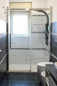 a bathroom with a shower and a toilet and a window at GIKLA MAISON in Catania +35 photos