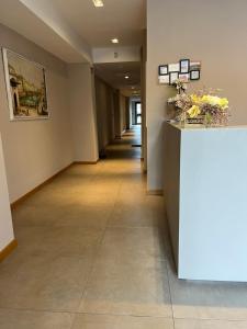 a hallway in a building with a counter with flowers on it at Appartamenti la Piazzetta vicino a Firenze in Signa