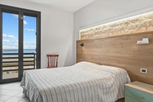 a bedroom with a bed and a view of the ocean at Case Vacanze Celeste in Marzamemi