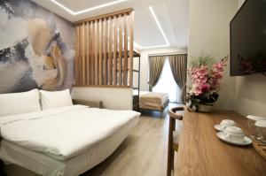 a bedroom with a bed and a table with flowers at Forty Nişantaşı Hotel & SPA in Istanbul