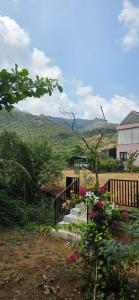 a stairway leading to a house with mountains in the background at Nirmala's Farmhouse - The Blu room in Kuttālam