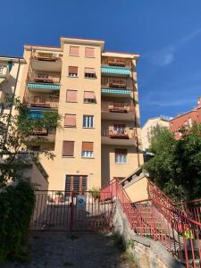 a tall building with a red fence in front of it at Casa Nora in Trieste +2 photos