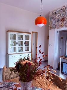 a living room with a vase of flowers on a table at La Casetta di Dante in Marina di Carrara