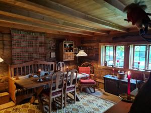 a dining room with a wooden table and chairs at Rongen gard in Bolstadøyri