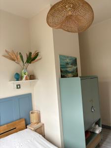 a bedroom with a bed and a lamp and a refrigerator at La Casetta di Dante in Marina di Carrara