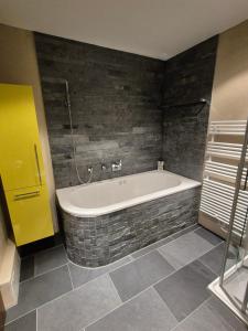 a bathroom with a bath tub in a room at ABO - Boutique Apartment - Chalet Horst in Grindelwald +13 photos