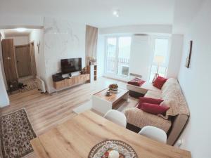 a living room with a couch and a tv at Murphy's Apartment in Mavrovo