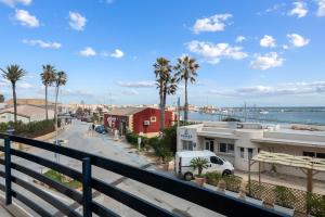 a view from a balcony of a street with palm trees at Case Vacanze Celeste in Marzamemi