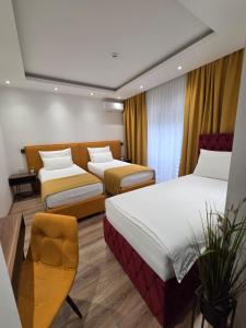 a hotel room with two beds and a chair at Hotel Premium in Jajce +83 photos