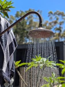 a bird bath with a shower head at Stunning Bush Beach House! NEW! in Elizabeth Beach +64 photos