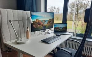 a desk with a computer and a laptop on it at Apartment An der Weinstraße in Oberotterbach +47 photos