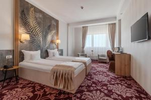 Un televizor și/sau centru de divertisment la Hotel Nevis Wellness & SPA