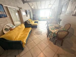 a living room with a couch and a table at residence caramboles in Fort-de-France